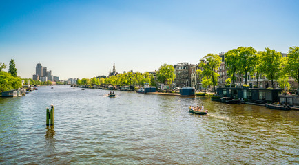 Amsterdam, May 7 2018 - view from the New Amstelbrug on the river Amstel near the center of Amsterdam in summertime