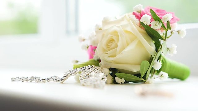 Bouquet of the bride with earrings and bridal wedding ring