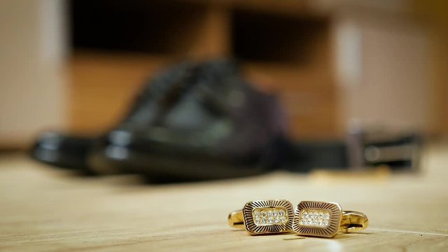 bride's shoes and gold cufflinks
