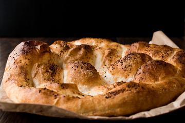 Turkish Ramadan Bread - Ramazan Pidesi on wooden surface / Pide