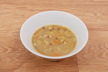 Soup with pasta and vegetables on a table