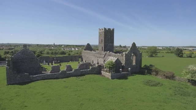 Beautiful scenic old ruins of Clare Abbey in County Clare, Ireland. Irish rural countryside with old Irish religious Abbey in decay.