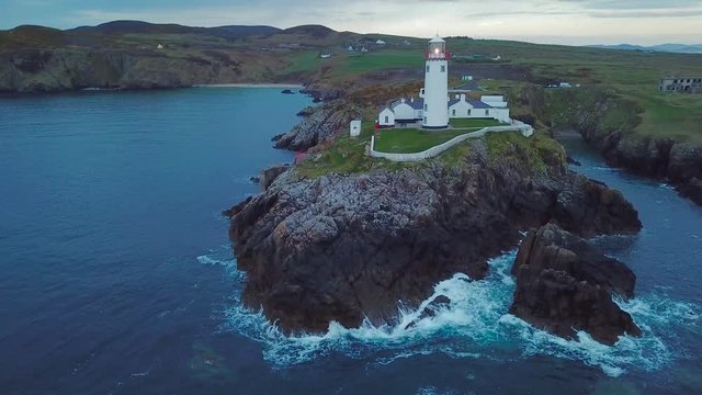 aerial footage of beautiful lighthouse on a cliff in Fanad, Ireland