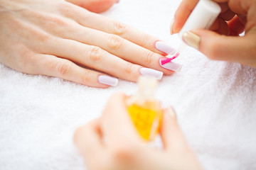 Obraz na płótnie Canvas Beauty and Care. Manicure Master Applying Nail Polish in Beauty Salon. Beautiful Women's Hands with Perfect Manicure. Spa Manicure.