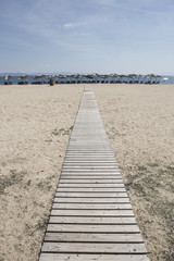 Fototapeta premium wooden boards ,walkway for beutiful sand beach with sun-beds