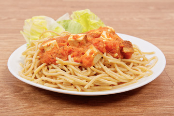 Bolognese spaghetti with tofu on a table