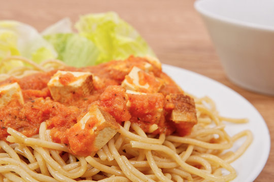 Bolognese spaghetti with tofu on a table