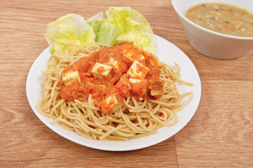 Bolognese spaghetti with tofu on a table