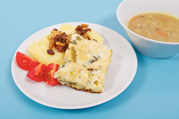Baked leek with mashed potatoes on a blue