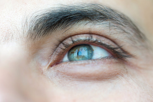 Close up on a blue eye of a man, unrecognisable