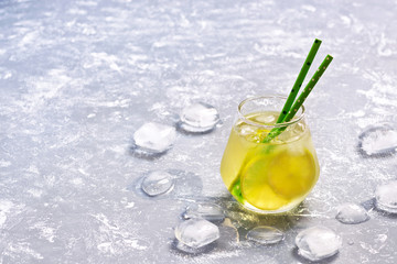 Cold drink with lime in a glass. Summer refreshing drink.