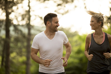 Couple jogging outdoors in nature