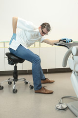 Male dentist exercising in his office waiting for patient