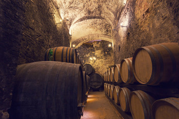 Wooden barrels with wine in a wine vault