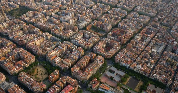 Aerial above Barcelona city buildings and streets, Spain