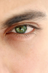 Close up on a green eye of a man, unrecognizable