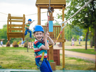 Young boy playing and having fun doing activities outdoors. Happiness and happy childhood concept