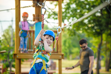Obraz premium Young boy playing and having fun doing activities outdoors. Happiness and happy childhood concept