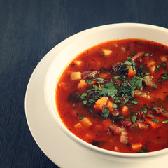 Tomato soup with red beans, potato and carrot. Vegan diet. European cuisine. Vegetarian dish. Main course. Organic meal. Toned photo.