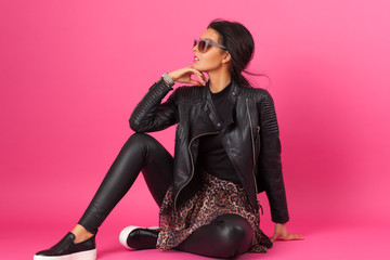 Fashion photography of model in the studio with pink background