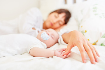 Hand der Mutter und Hand von Baby