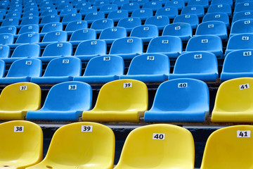 Yellow and blue plastic seats in the stadium.
