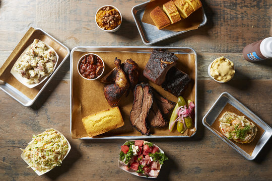 Overhead view of fresh meal served in trays on wooden table
