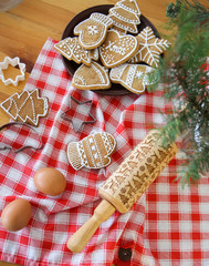 Fototapeta na wymiar holiday gingerbread Christmas items glaze decorated table
