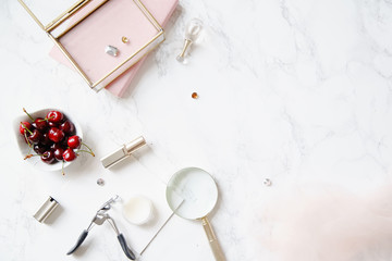 Flatlay with feminine accessories and red high-heeled shoes on marble background