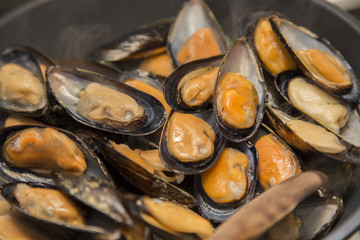 close-up of mussels cooking in a pan