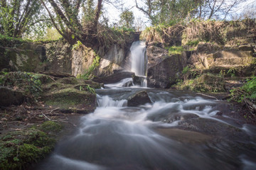 Fototapeta na wymiar long exposure of a waterfall in the natural park of 
