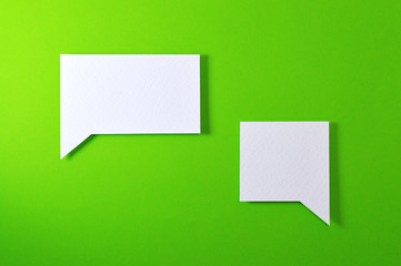 couple of angular text bubble on green background