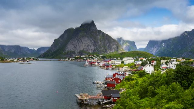 4k timelaspe Moving clouds over traditional Norwegian fisherman's cabins, rorbuer, on the island of Hamnoy, Reine, Lofoten islands, Summer of Norway.