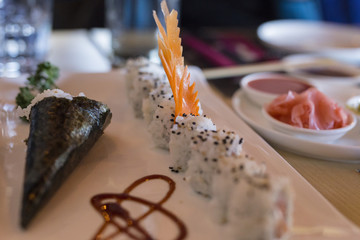 closeup of chinese food with sushi in plate with decorations