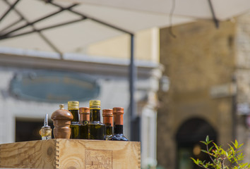 closeup of crate with oil bottles and condiments
