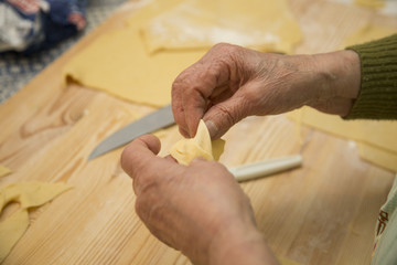 closeup of hands of housewife working fresh pasta