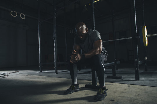 Male athlete relaxing in gym