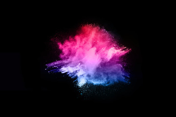 Multicolor powder explosion on black background. 