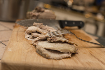 Fototapeta na wymiar closeup of roasted meat slices on wooden chopping board 5