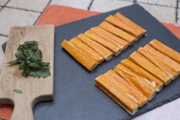 preparation of fish sticks with crab meat called surimi