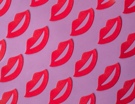 Red female lips pattern on pink background