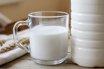 a glass of fresh milk on the wooden table