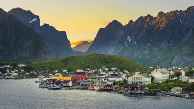 4k timelaspe Sunset Scene of Moving clouds over traditional Norwegian fisherman's cabins, rorbuer, on the island of Hamnoy, Reine, Lofoten islands, Summer of Norway.