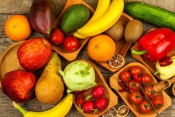 Different types of vegetables and fruits on a wooden table. Concept of healthy food. Dietary foods.