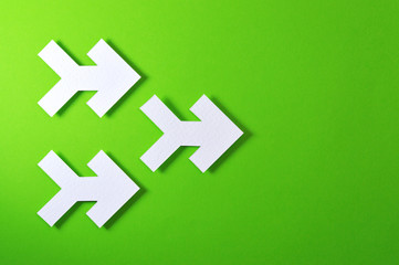 three arrows on green background