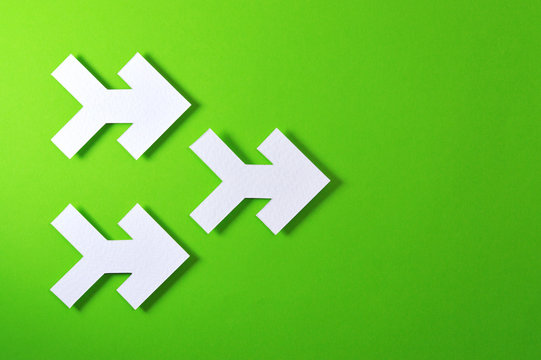 three arrows on green background
