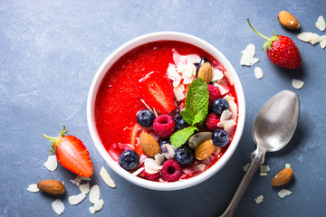 Smoothie bowl with fresh berries and nuts. 