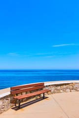 Fototapeta premium Bench near blue sea