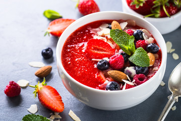 Smoothie bowl with fresh berries and nuts. 