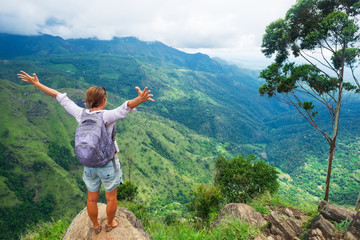 Caucasian woman standing and looking on mountain and valley. Concept of travelling in Sri Lanka